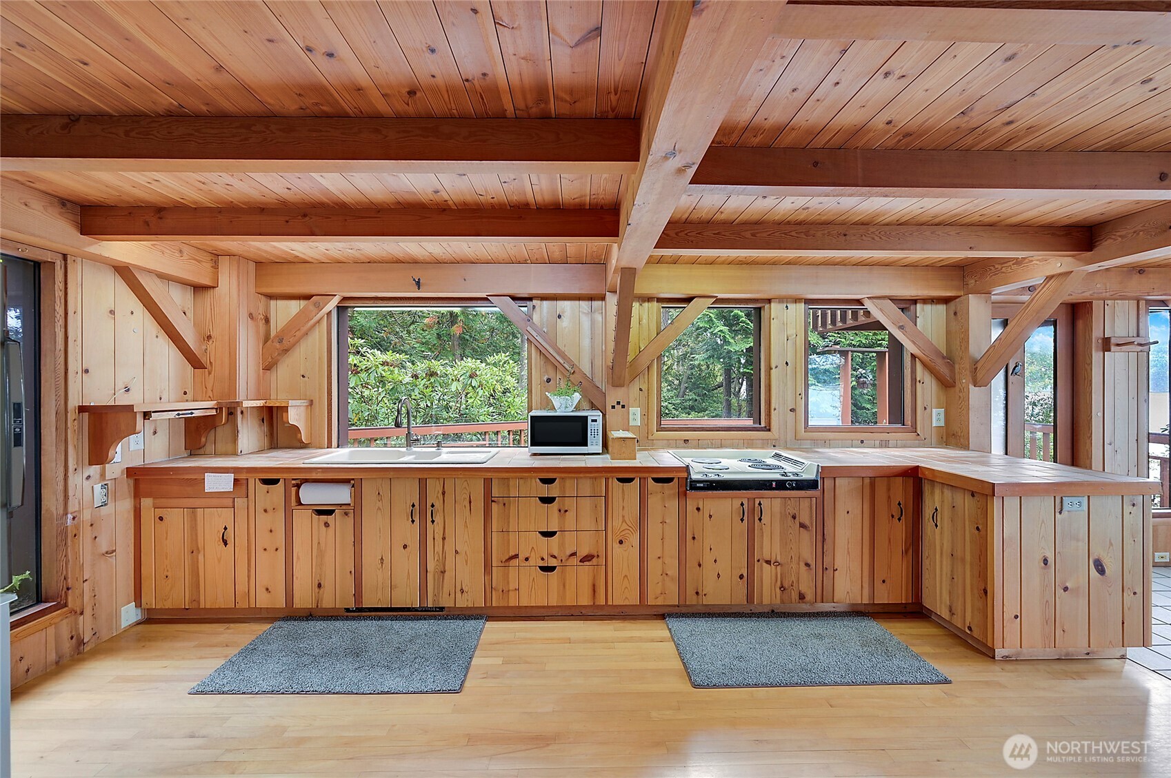 861 Griffith Point Road Nordland, WA 98358 - Photo 8 of 38 a large kitchen with wooden cabinets and a sink