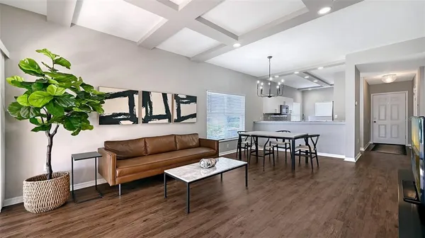 a bedroom with bed and a chandelier