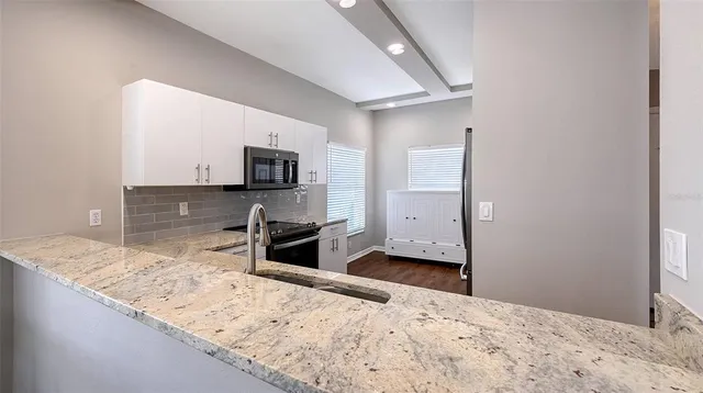 a bedroom with a bed and chair