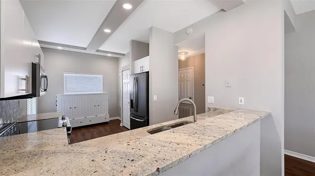 a spacious bathroom with a granite countertop sink mirror and shower