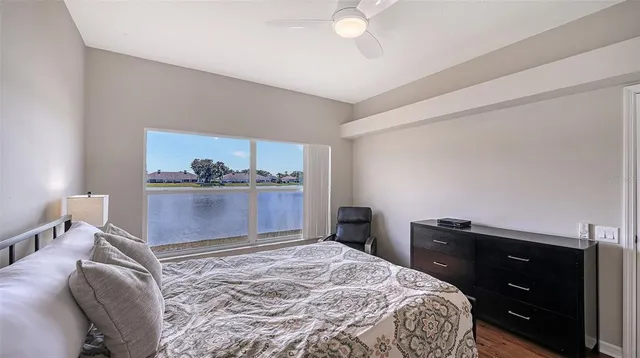 an aerial view of a city with lots of residential buildings ocean and mountain view in back