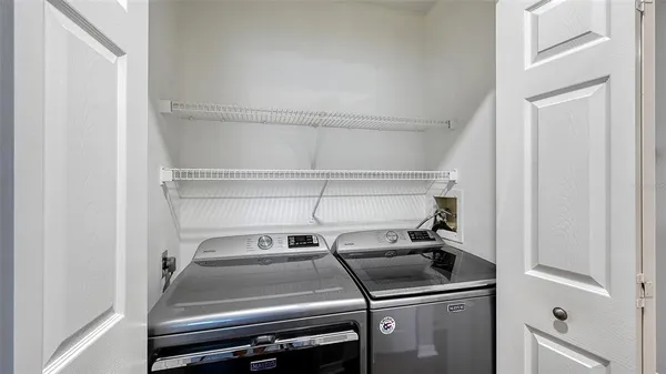 a view of a park bench and a fountain in the background