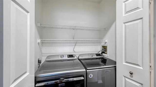 a view of a park bench and a fountain in the background