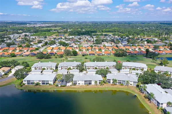 a view of a house with swimming pool and a yard