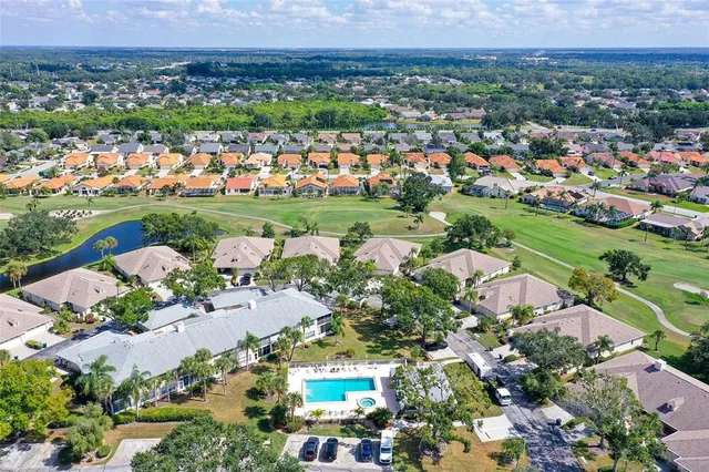 a view of a patio with a table and chairs under an umbrella