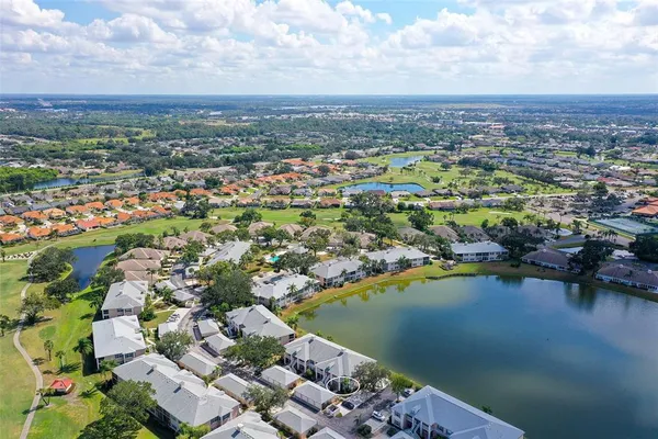 an aerial view of a house with a garden and lake view