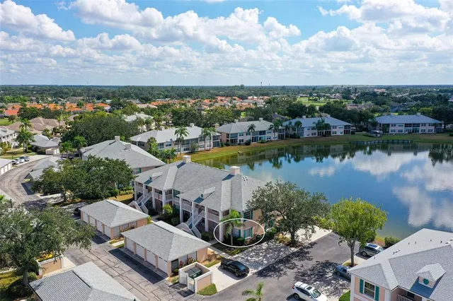 a living room with furniture a flat screen tv and a floor to ceiling window