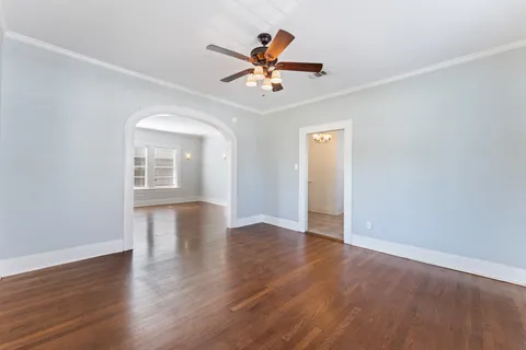 an empty room with wooden floor a ceiling fan and closet