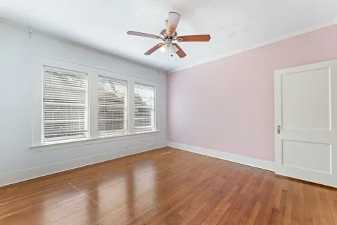 a view of a livingroom with a ceiling fan and window