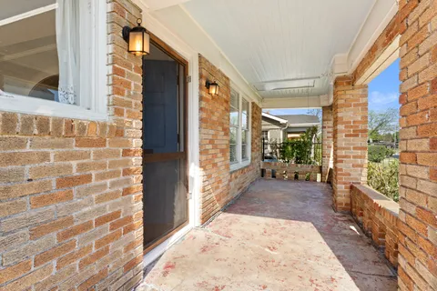 a view of a brick house with a large windows