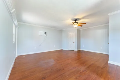 a view of an empty room with a ceiling fan