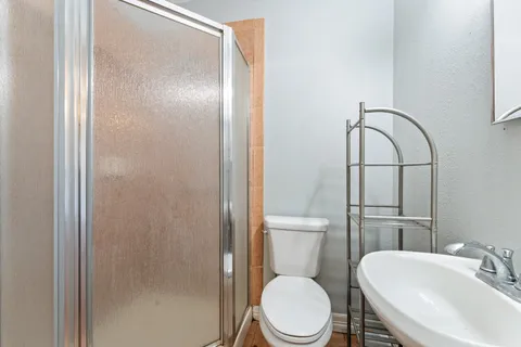 a white toilet sitting next to a bathroom sink