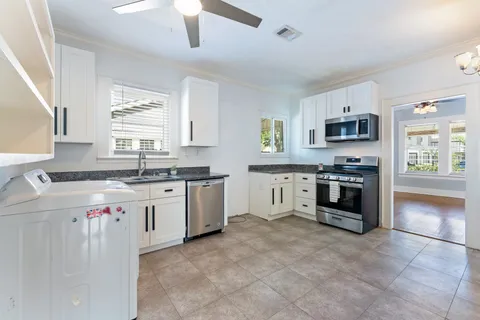 a kitchen with a sink stove and microwave