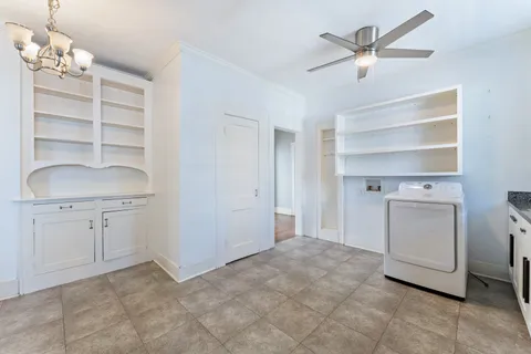 a room with a cabinets and a ceiling fan