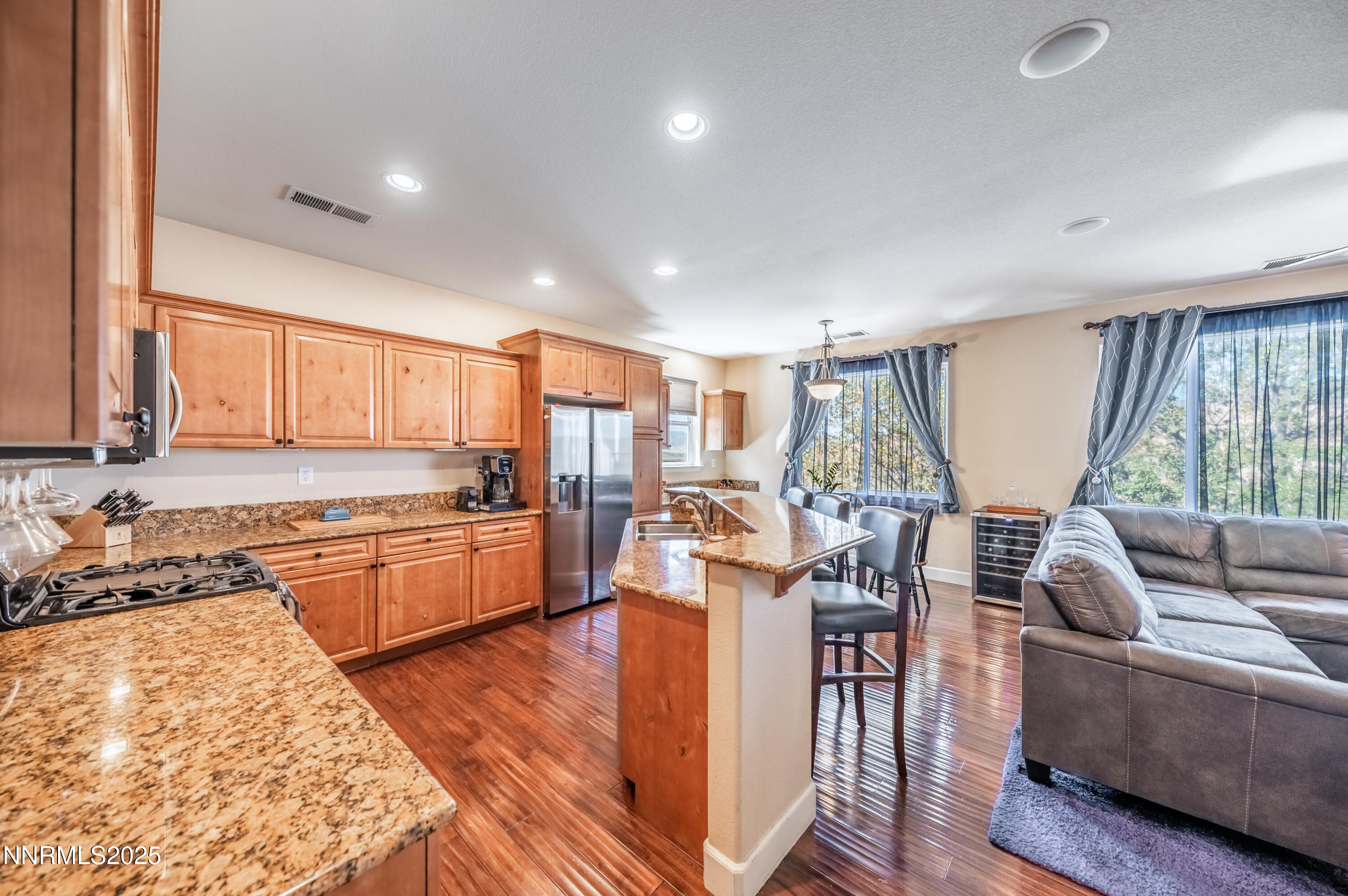 3715 Coastal Street Reno, NV 89512 - Photo 5 of 35 a large open kitchen with a large window and stainless steel appliances