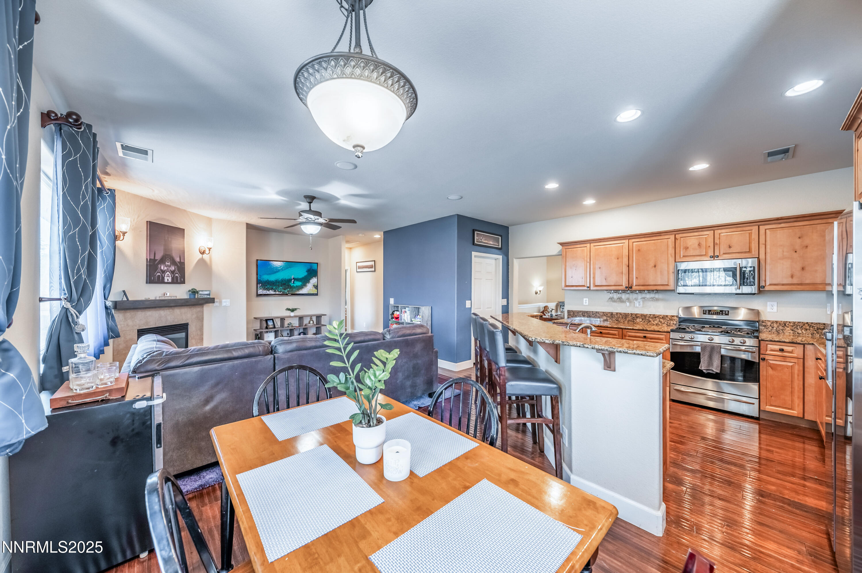 3715 Coastal Street Reno, NV 89512 - Photo 10 of 35 a living room with stainless steel appliances kitchen island granite countertop furniture wooden floor and a rug
