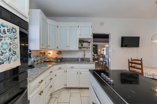 a kitchen with stainless steel appliances a stove a sink and a microwave