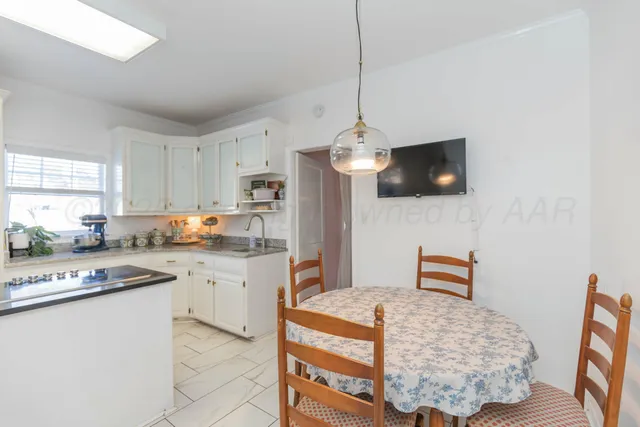 a kitchen with a sink cabinets and window