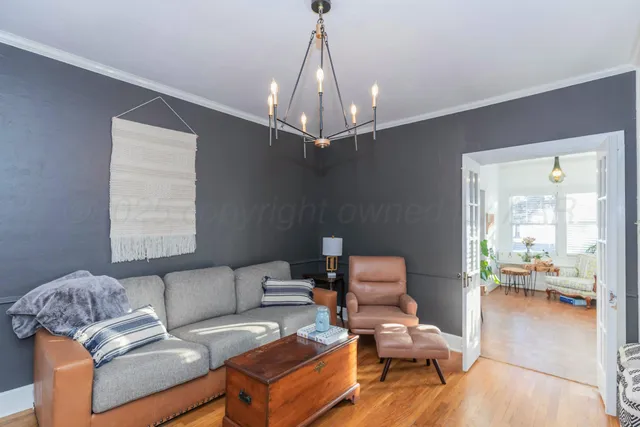 a living room with furniture and a chandelier