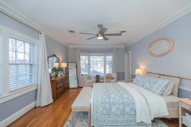 a bedroom with a large bed and a chandelier