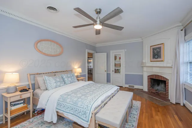 a bedroom with a large bed and a fireplace