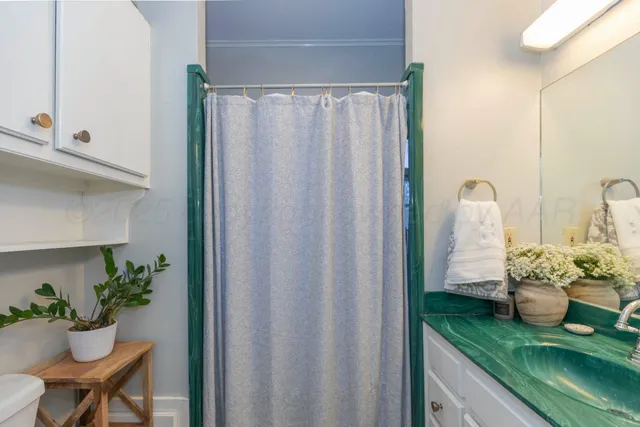 a dining room with furniture and flower vase