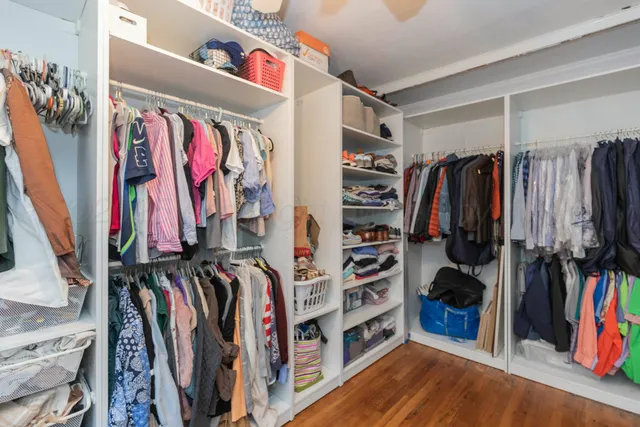 a view of walk in closet with clothes