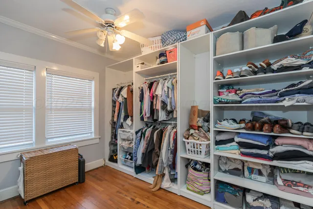 a view of walk in closet with clothes and shoes