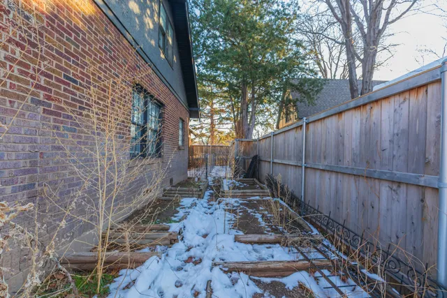 a view of a backyard with wooden fence