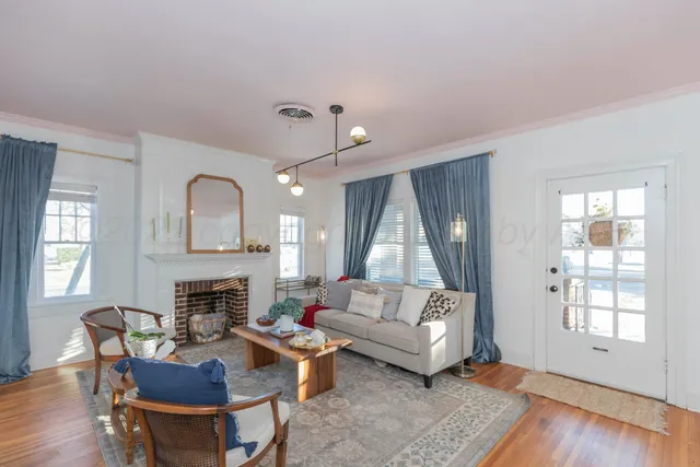 a living room with furniture and a fireplace