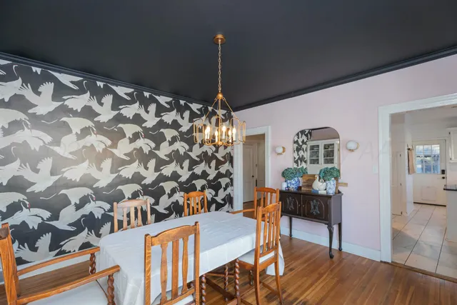 a dining room with furniture and wooden floor