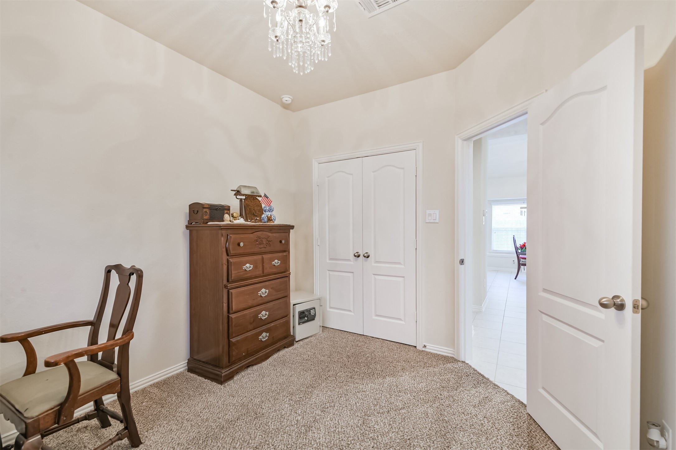 7527 Windsor Valley Lane Houston, TX 77049 - Photo 30 of 35 a room with a dresser and chair