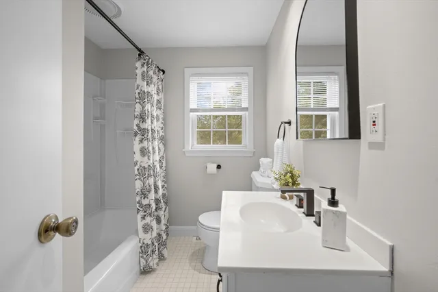 a bathroom with a sink toilet and tub