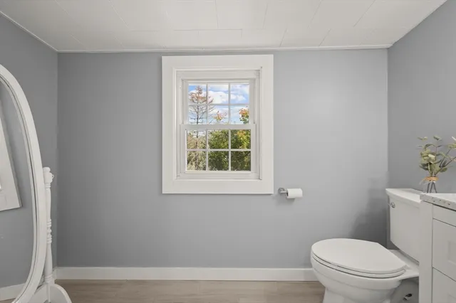 a white toilet sitting next to a window