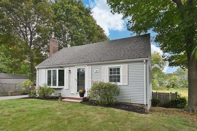 a house that has a tree in front of it