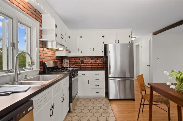a kitchen with granite countertop a refrigerator and a sink