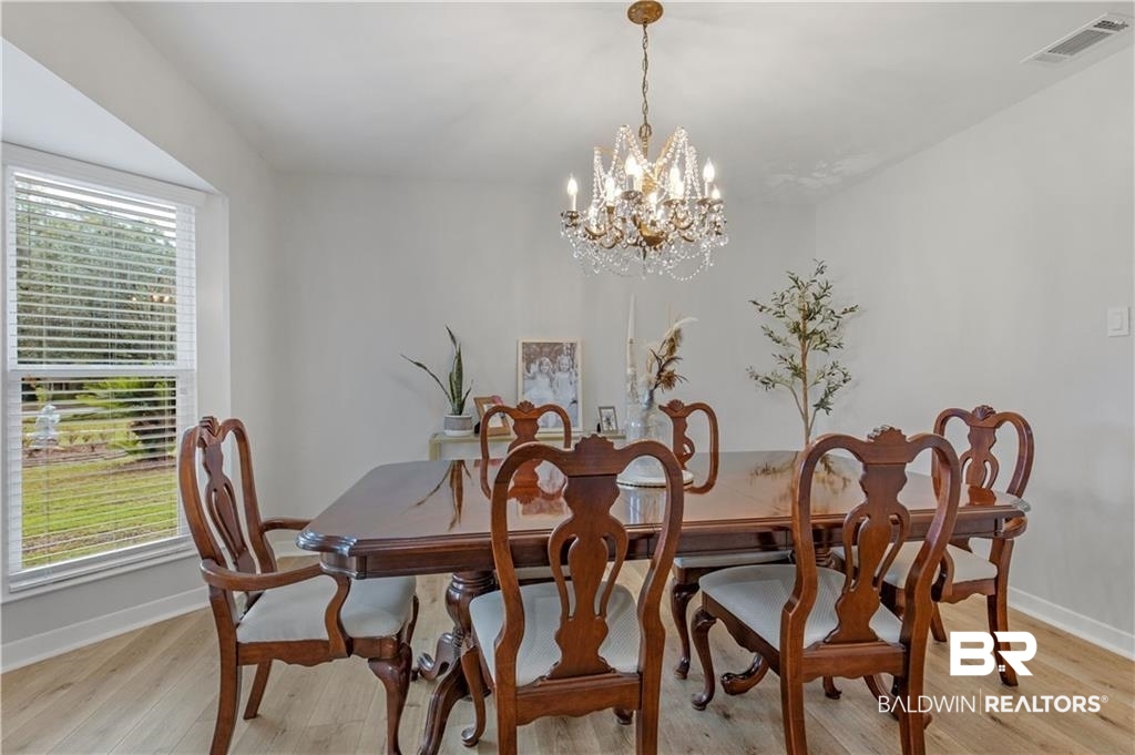 1624 Apex Drive Mobile, AL 36693 - Photo 17 of 29 Dining space with a healthy amount of sunlight, light hardwood / wood-style flooring, and a chandelier