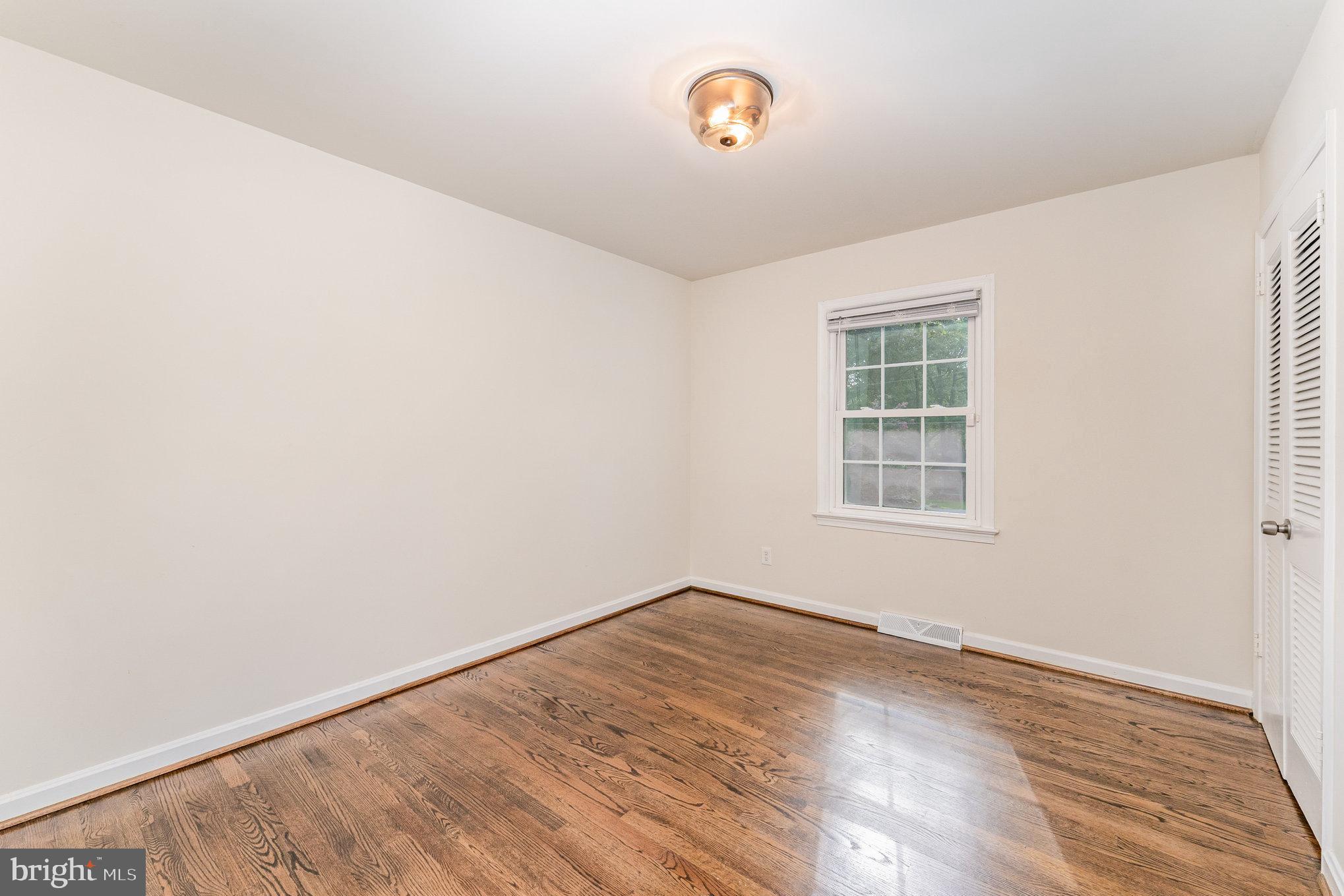112 Jay Road Fredericksburg, VA 22405 - Photo 27 of 44 an empty room with wooden floor and windows