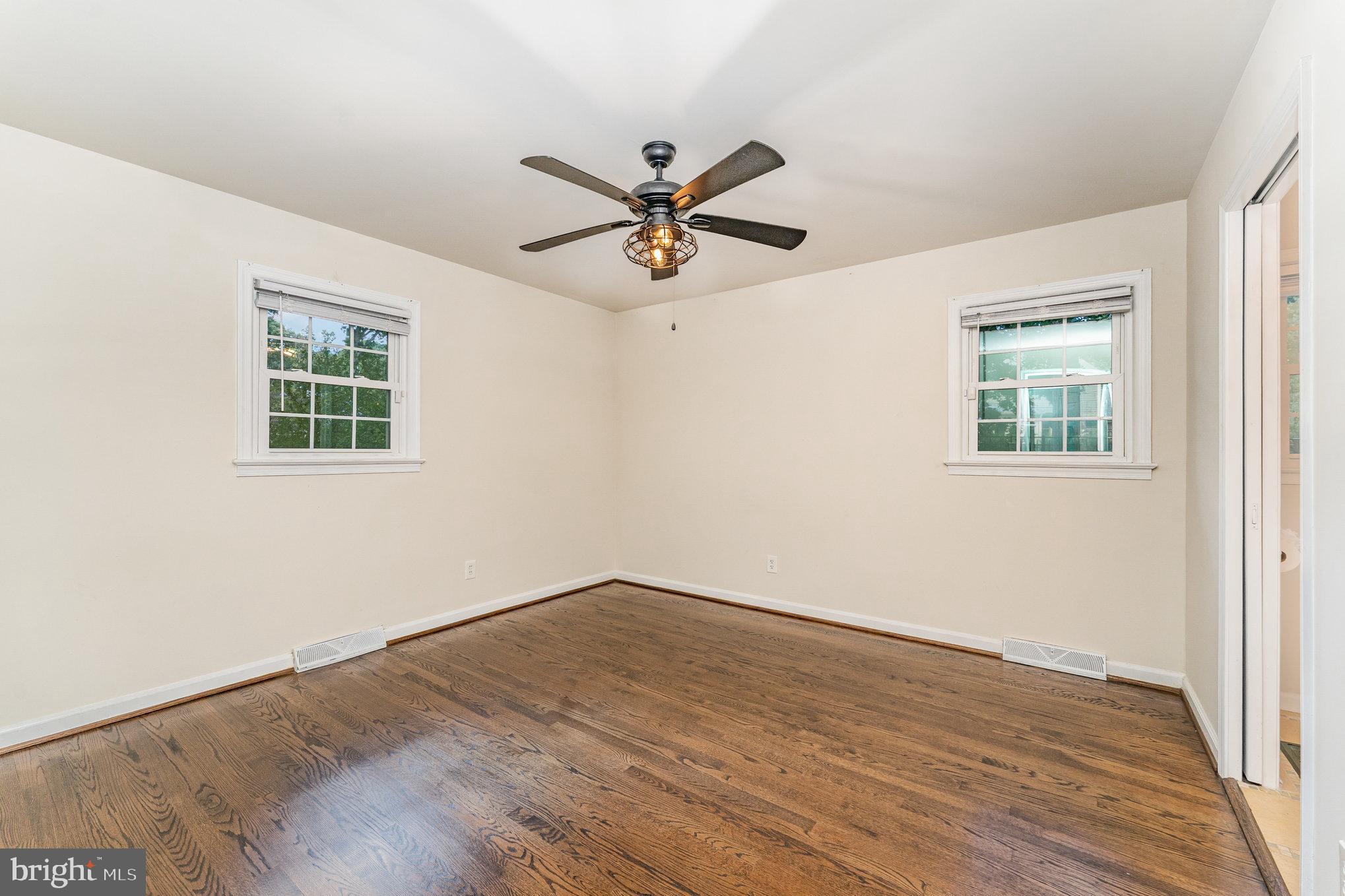 112 Jay Road Fredericksburg, VA 22405 - Photo 34 of 44 an empty room with wooden floor ceiling fan and windows