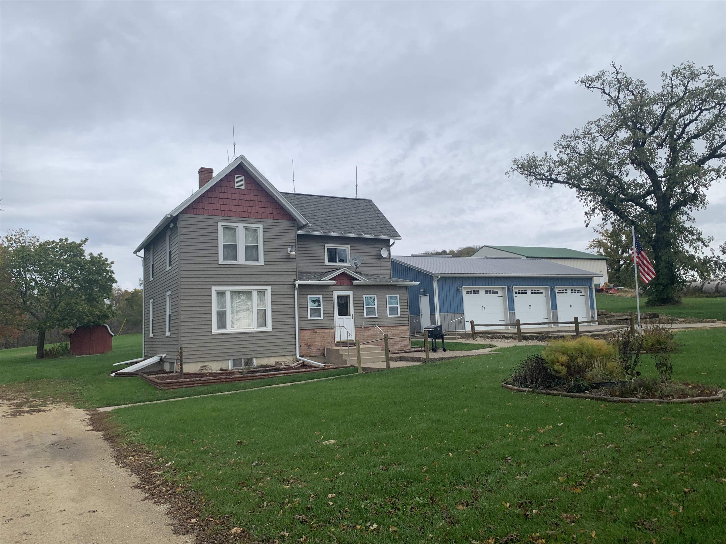1796 East Hanover Road Elizabeth, IL 61028 - Photo 1 of 2 a front view of a house with a garden and trees