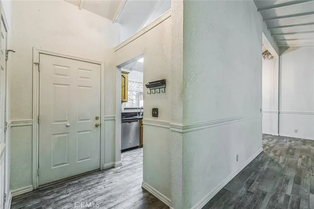 a view of a hallway with a refrigerator