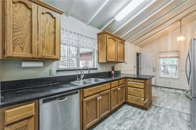 a kitchen with stainless steel appliances granite countertop a stove and a sink