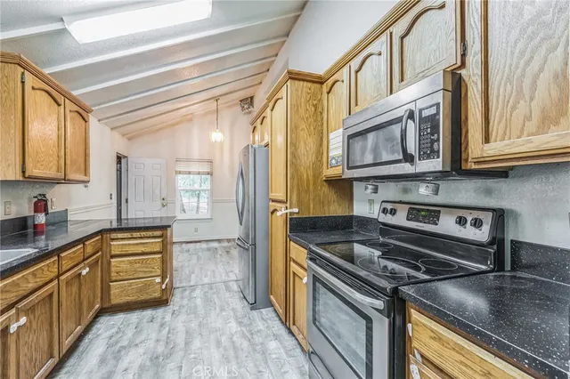 a kitchen with stainless steel appliances granite countertop a sink a stove and cabinets