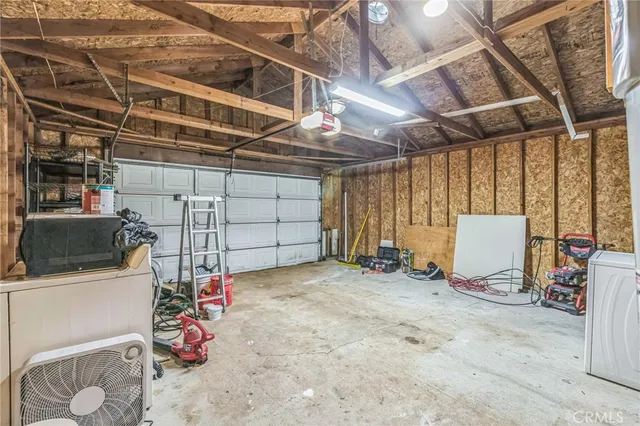 a view of a livingroom with a flat screen tv ceiling fan and window