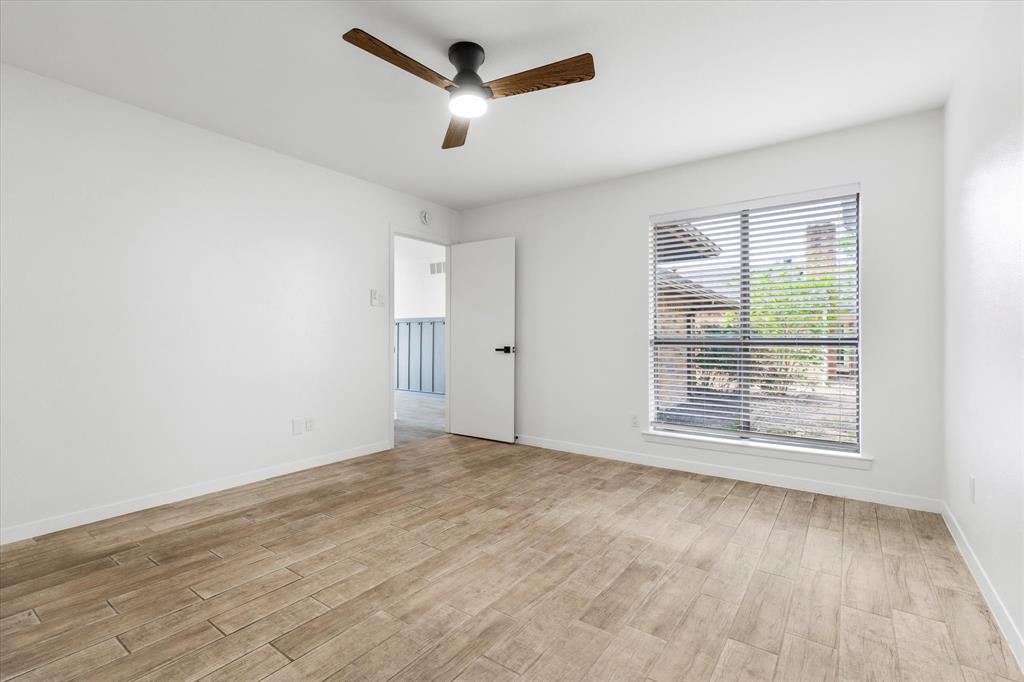 17003 Davenport Road Dallas, TX 75248 - Photo 35 of 40 an empty room with wooden floor and windows