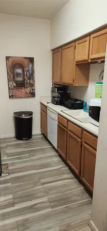 a room with wooden floor and cabinets