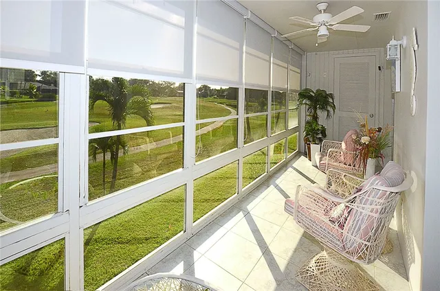 a view of a porch with furniture and garden