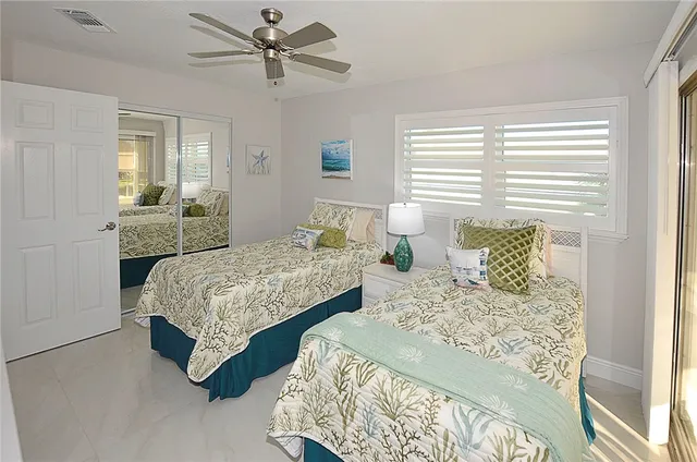 a bedroom with two beds and painting on the wall