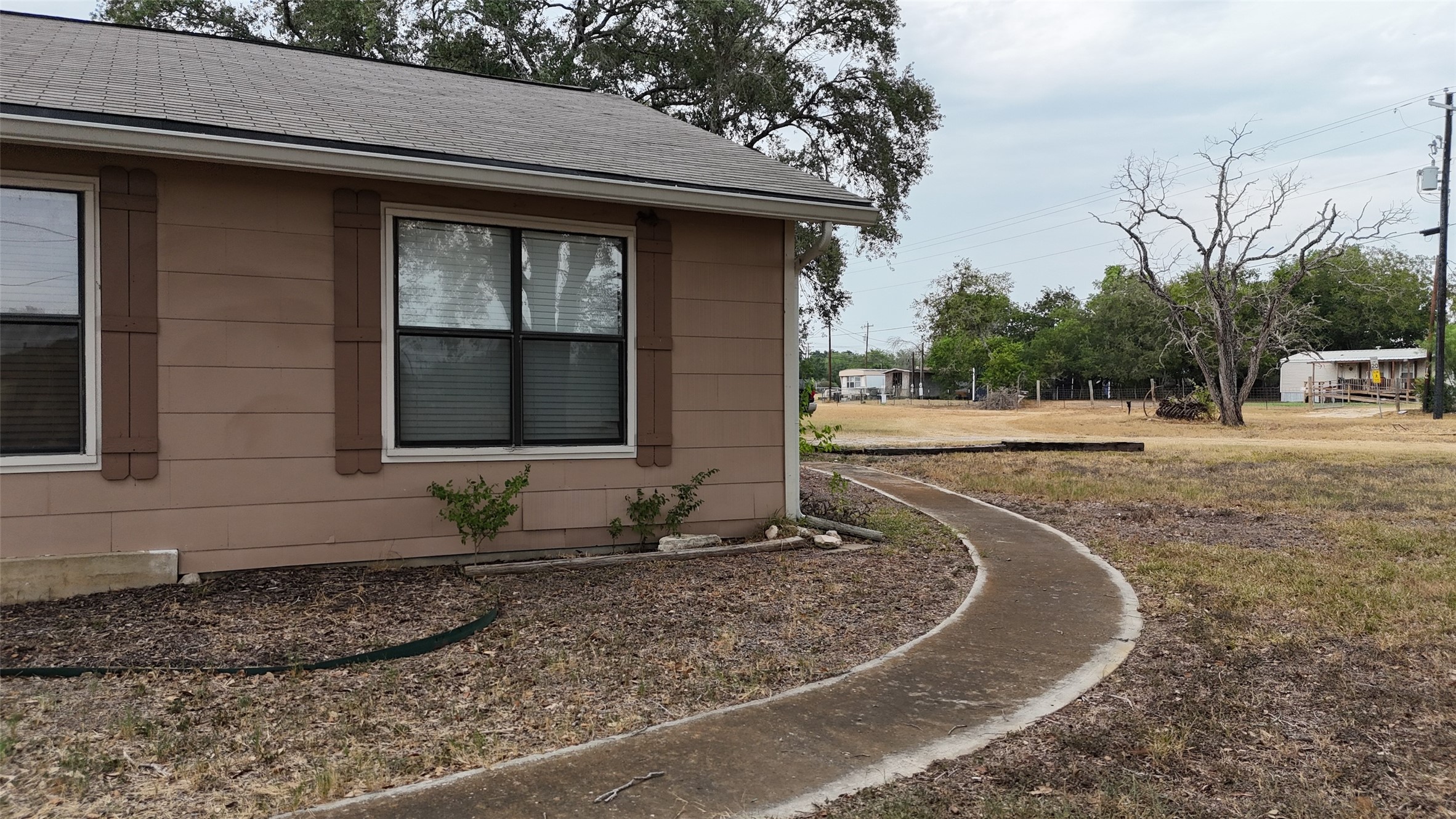 307 5th Street Sutherland Springs, TX 78161 - Photo 2 of 16 a front view of a house with trees