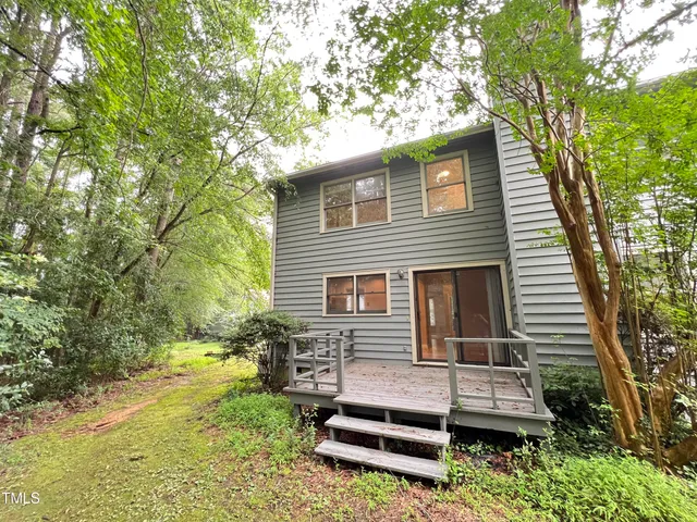 a house that has a tree in the yard